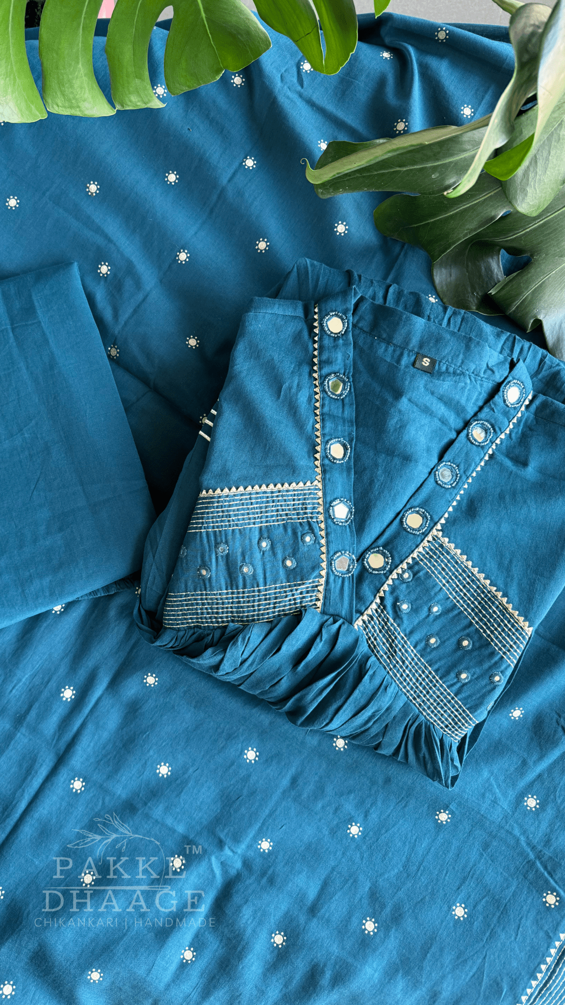 Teal blue kurta set with contrast embroidery and mirror work, showcased