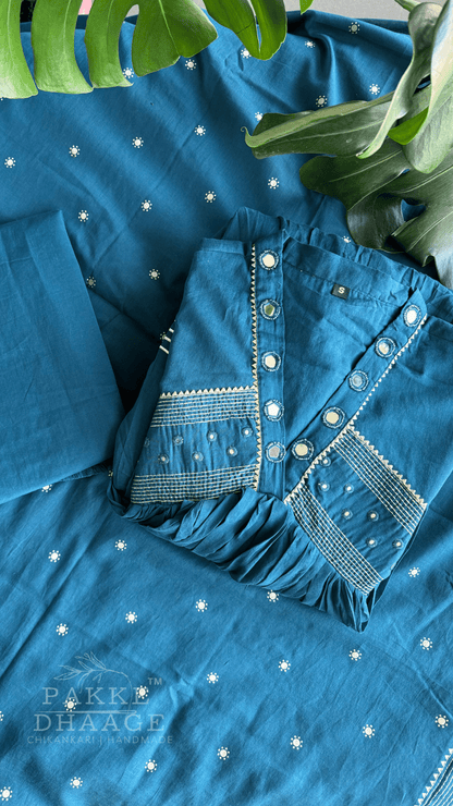 Teal blue kurta set with contrast embroidery and mirror work, showcased