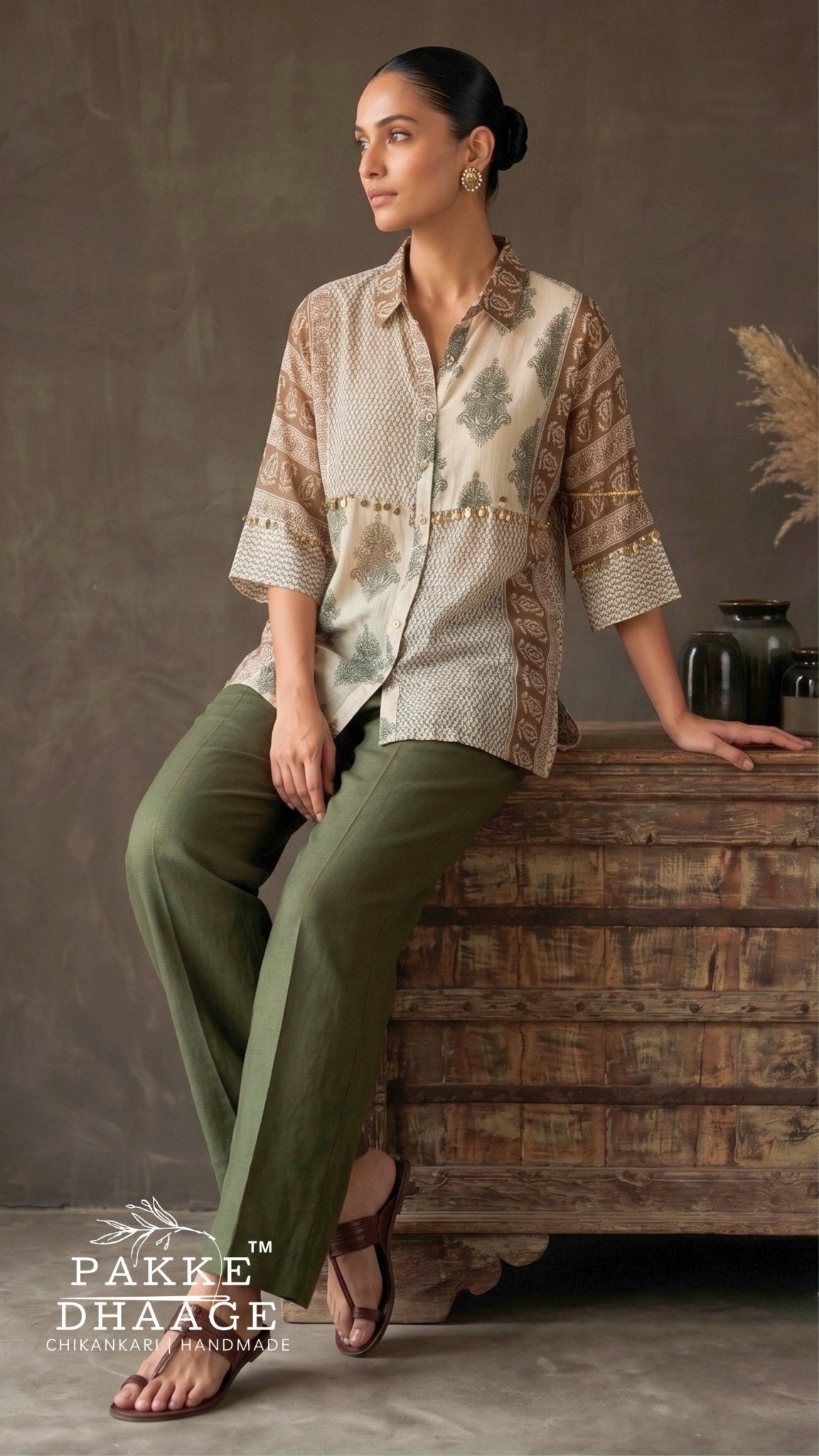 Model wearing Pakke Dhaage earthy patchwork sheer muslin shirt with gold coin trim and included gossamer inner, paired with olive green trousers.