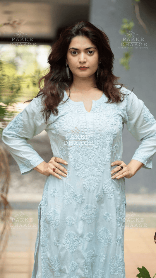 Woman wearing a light blue / aqua embroidered kurta with chikankari work