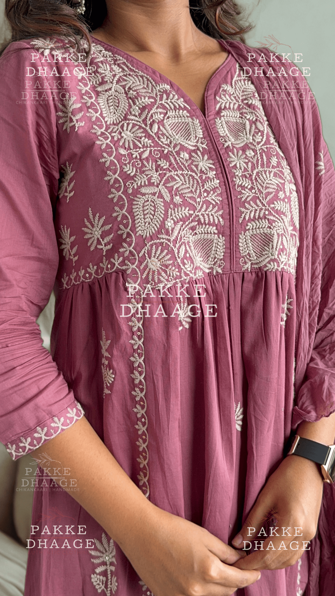 Purple embroidered dress with 'Pakke Dhaage' branding on a light gray background