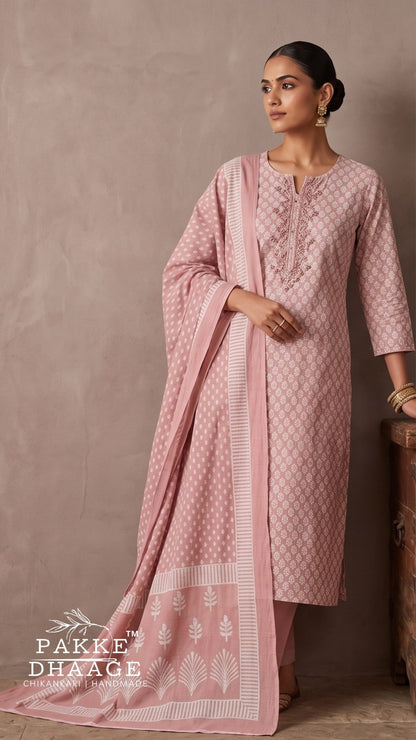 A woman models a light pink ethnic kurta set with matching dupatta. The kurta features a white geometric pattern, a printed neckline, and a matching printed dupatta with a white border. | Pakke Dhaage