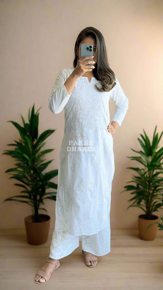 Person wearing a traditional white chikankari outfit