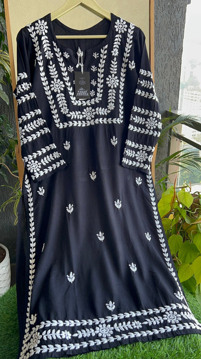 Black dress with white floral patterned Chikankari against a neutral background